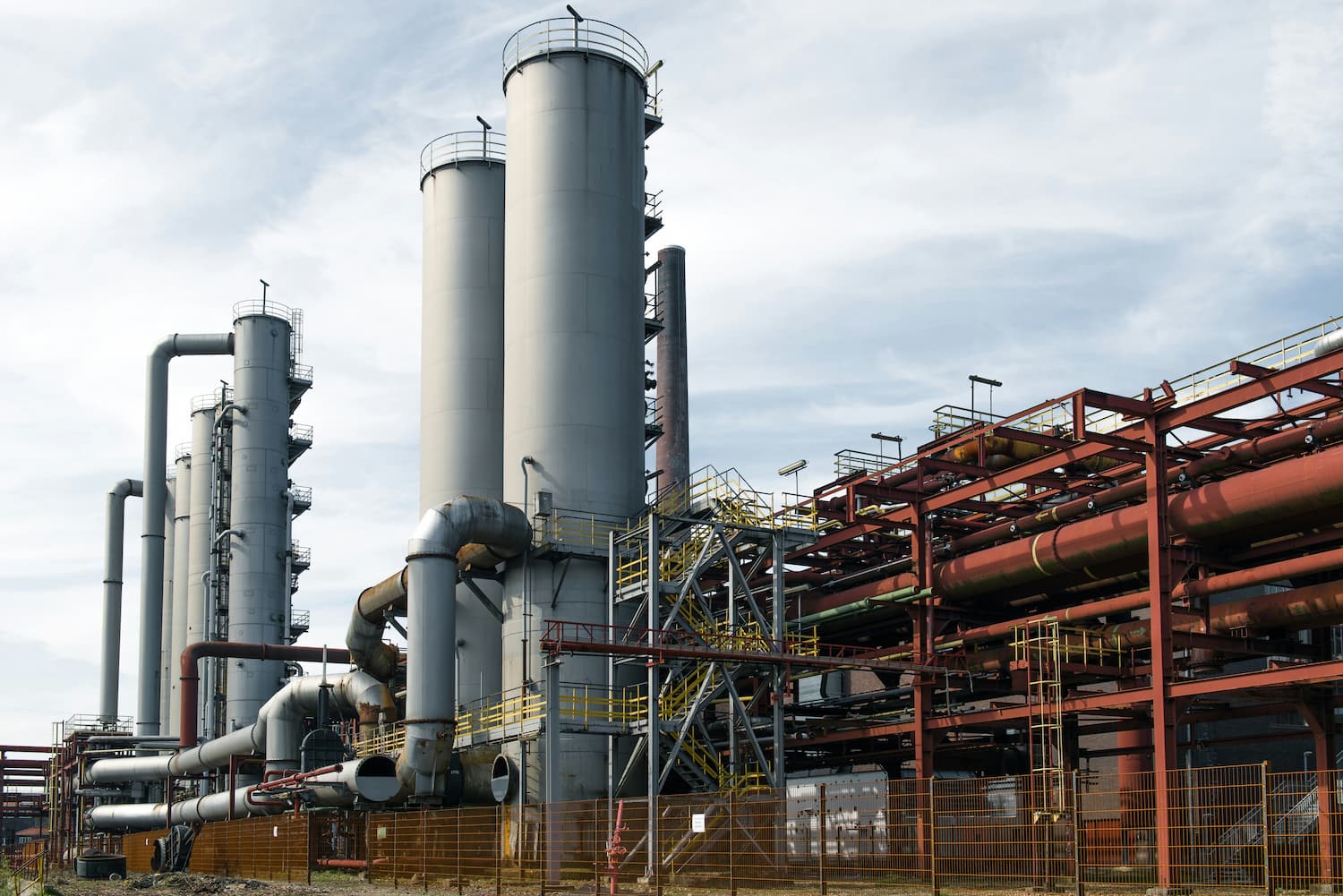 Industrial plant with extensive pipework and storage tanks, representing operational technology infrastructure at a COMAH site.